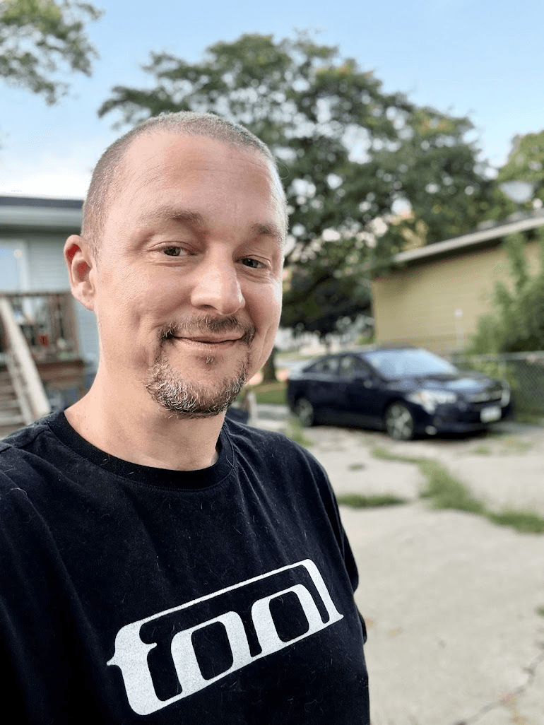 Tony Simons outdoors wearing a black TOOL t-shirt